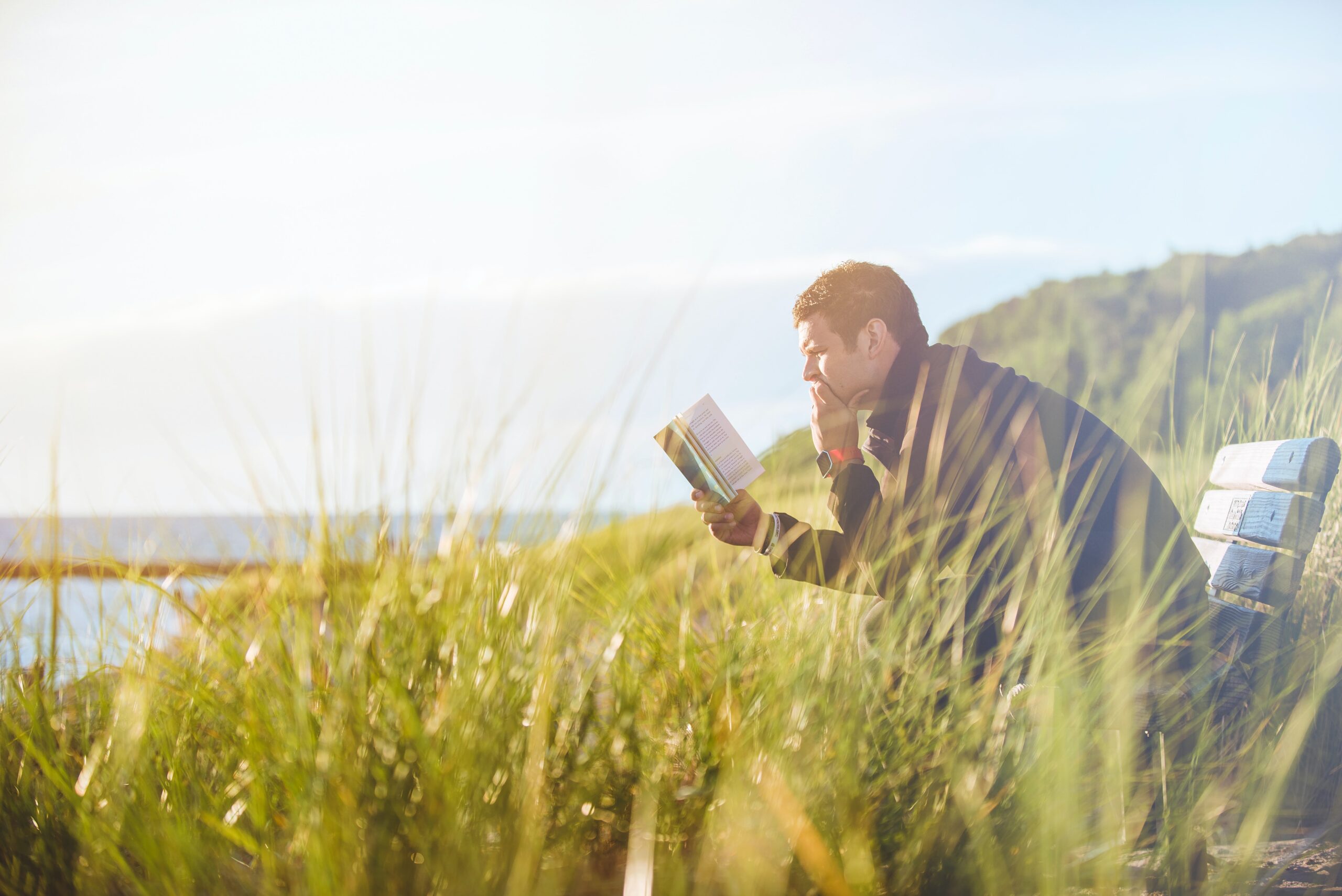 a man sitting reading a book